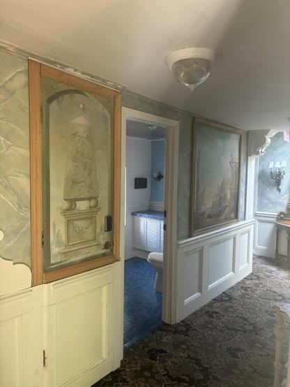 The painting/ hidden door to our tiny staircase hidden hotel room.