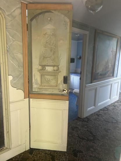 The painting/ hidden door to our tiny staircase hidden hotel room