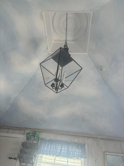 Once you climbed the hidden stairs, you get to a small sunny room with they sky painted on the vaulted ceiling.