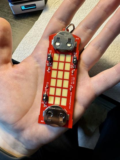 The back of the 44CON badge showing all the populated components in my hand.