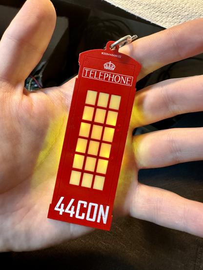 The badge from the front switched on in my hand. It’s a red telephone box that says 44CON at the bottom with RGB LEDs lighting up the translucent window panels.