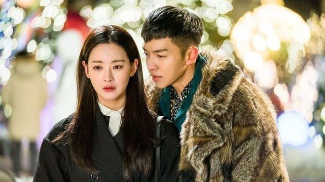 Oh Yeon Seo & Lee Seung Gi standing outside in winter coats in a scene from the 2017 South Korean drama "A Korean Odyssey"