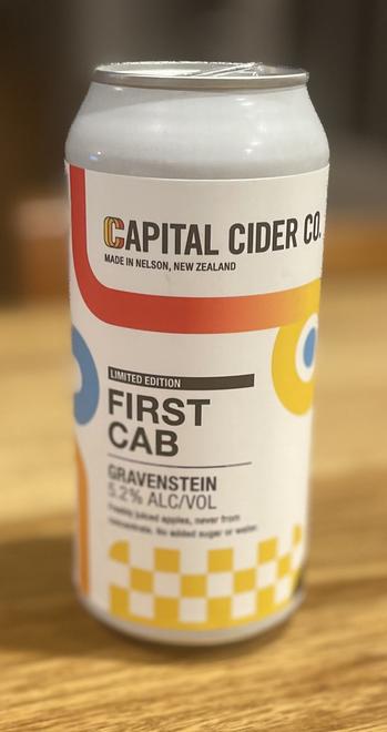 A colour photo of a can of apple cider. The label reads "Capital Cider Co. Made in Nelson, New Zealand, Limited Edition, First cab, Gravenstein 5.2% ALC/VOL."