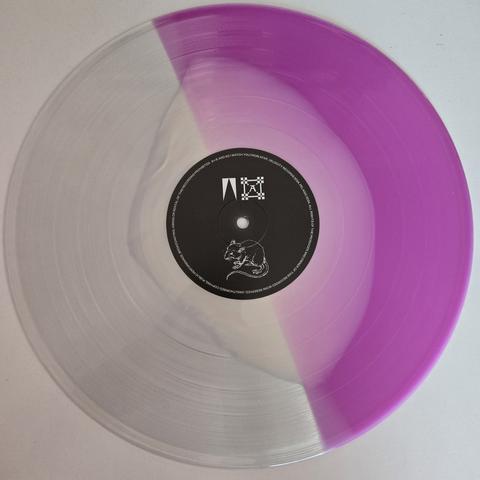 And So I Watch You From Afar's "Megafauna" gatefold LP, Subscriber Edition vinyl, Side A - half pink, half transparent with irregularly-shaped white blob in the middle, flowing into both halves
