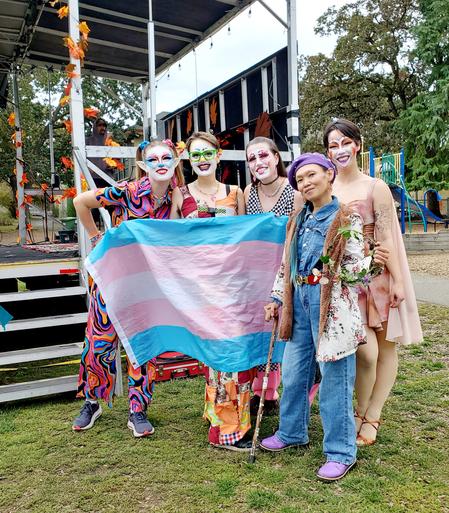 Me & the clown car drag show performers, stage side, with a trans flag ❤️