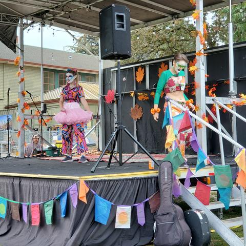 Clown Car Drag Performers, one on stage as one leaves stage.