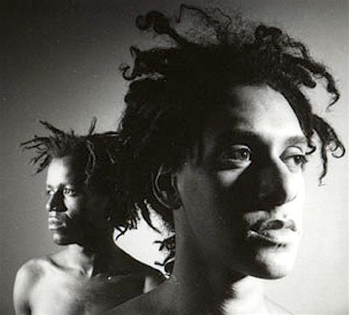 alex and rudy from a.r. kane. two black guys with medium length dreadlocks, close to the camera looking in different directions. black and white photograph.