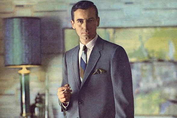 1963 

A man dressed elegantly stands indoors, holding a lit cigarette between his fingers.
His expression is serious and contemplative.
Tags: vintage photograph, formal attire, indoor setting, cigarette