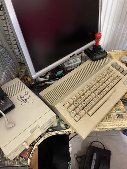 My C64 setup, with a 1541-2 floppy. On the top right, there’s an original al signature of John Romero, creator of DOOM