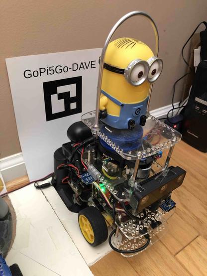 Picture of the actual GoPi5Go-Dave robot, with minion Dave atop the robot.