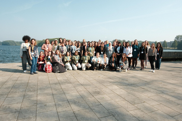 group picture of women in AI at Semantics 2024 in Amsterdam in front of a lake.