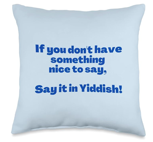 If you don't have something nice to say, say it in Yiddish is shown in blue lettering on a throw pilow.