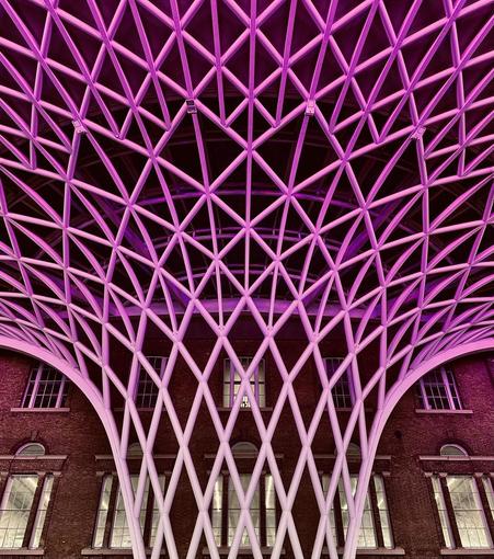 I tookt this photo at Kings Cross Station in London. Amazing construction. 
There are plenty of windows in the old original building in the background. 
The foreground is dominated by this magnificent construction to support the ceiling in the new part of the building.