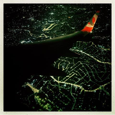 City of São Paulo at night seen from the plane window.