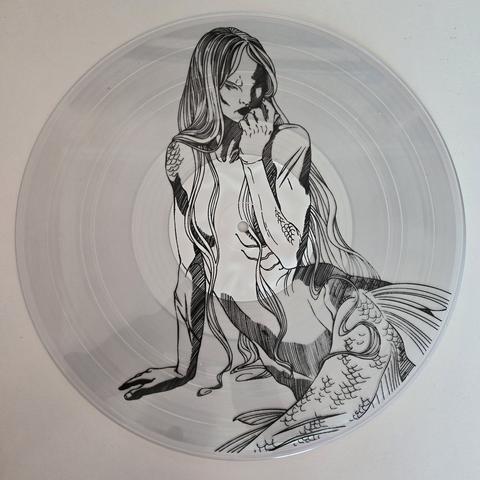 i Häxa's "Part Three" gatefold LP, Subscriber Edition vinyl, side B - transparent vinyl with a black and white line art of a siren, apparently sitting on a rock, thinking.