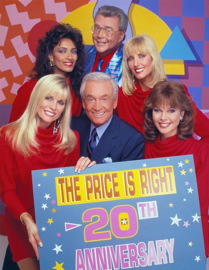 Cast poses with a sign celebrating thier 20th anniversary