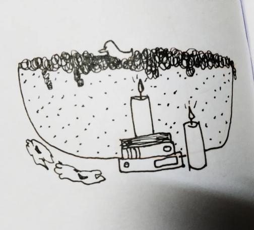 A cosy bathtub with candles and books.