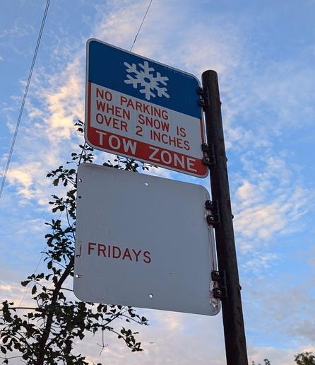 street sign where all the words have faded except the word "Fridays"