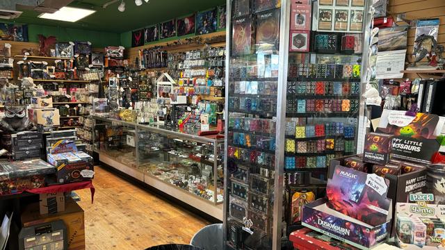 A panorama shot of the inside of Yellow King Games in Colorado Springs. Packed to the brim with gaming supplies.