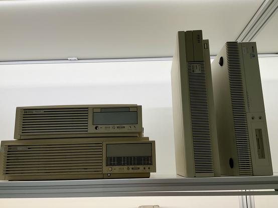 Four HP 9000 Series 700 workstations on a shelf.