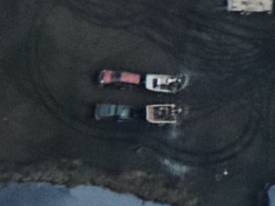 Two pickup trucks with airboats