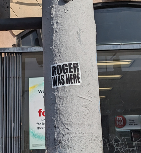 Sticker on a pole "Roger was here"