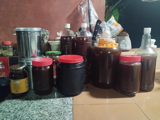 A foto of various containers all filled up with cane syrup.