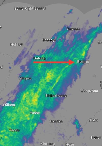 Weather radar shows a deep bank of light to moderate rain moving slowly over Beijing from the west