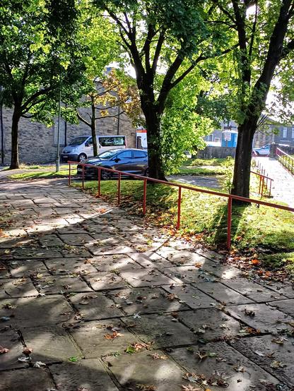 Dappled light falling on the flagstones on the entrance to the swimming pool.