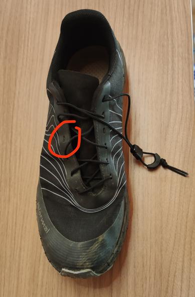 A Tomir shoes laced up with Decathlon quick laced. One set of lace holes are skipped and indicated by an scribbly circle.
