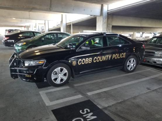 A Cobb County police cruiser in a parking deck