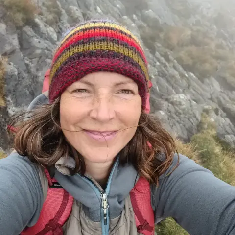 Portrait of me, wearing a woolly hat, on a mountain, in the fog.