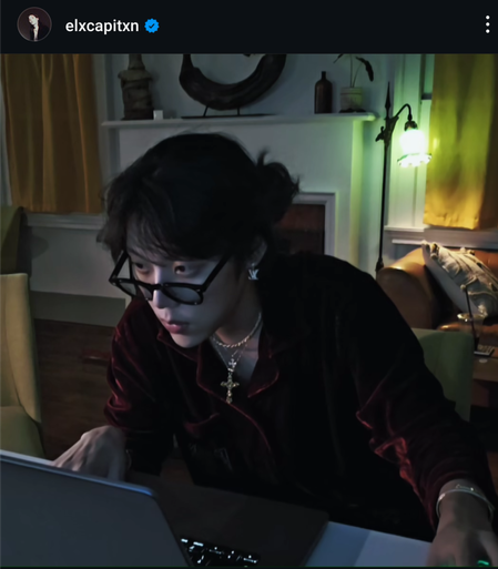 at his desk in a lamplit room
he's viewing a screen with reading glasses 
i wonder what's the music playing right now