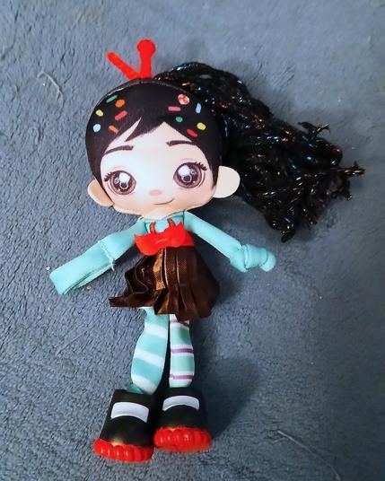A small ragdoll of Vanellope von Schweetz from Wreck-It Ralph. She has a knot and a fabric loop in place of hands,