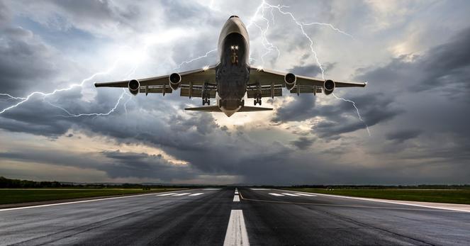 Composite photo of plane taking off with lightning behind it