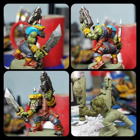 Collage of four pictures, 3 of 1 painted model and a fourth of an unpainted but primed model 

The paint model is wearing what looks like helmet and hefty shoulder pad, he is wielding a badass sword, and is pointing a gun up in the air. 

The unpainted model looks much the same barring the helmet, but as an extract this one has got several head stuck to the side of the sword that is pointing upwards for some unfathomable reason. I mean, it stands to reason that heads will be cut off, but there is this oddity of gravity that forces severed heads to start rolling across whatever flooring is available. They're not known for sticking around so to speak