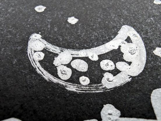 A minimalist desert scene under a moonlit sky, created using a pen plotter programmed to dip a paintbrush into silver metallic ink. The crescent moon floats above abstracted desert dunes and cacti, outlined in smooth lines. Scattered stars are represented with silver ink dabs, creating a serene, expansive night sky. The reflective quality of the silver ink against the black background evokes the calm and solitude of a desert night. In close-up, the textured silver ink stars have a cratered, hand-painted appearance, adding dimension. The crescent moon is detailed with metallic strokes, enhancing the organic feel of the scene. This piece meditates on the quiet of a desert night, its calm reinforced by each star and line being hand-programmed—each element unique, like every night spent under the sky.