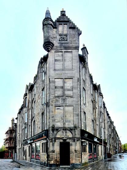A blonde sandstone Scots Baronial style corner tenement.