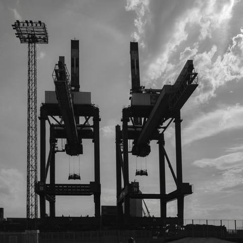 A black and white shot of two container bridges at container terminal Bremerhaven.