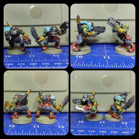 Two ork boyz

Both with handguns, both with helmets, both with too many leather straps because bitch please. One's got a sword, the other's got a chainsaw. They've also got the weapons in different hands!