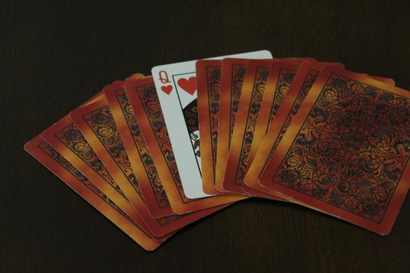 set of face down playing cards, with the queen of hearts showing
Photo by Laine Cooper on Unsplash