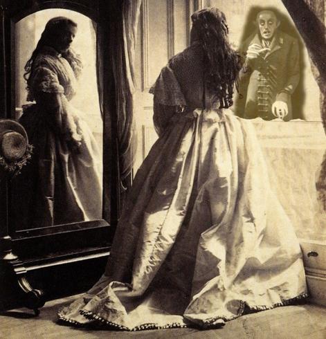 A photograph(1861) of Hawarden Clementina Maud, Lady (1822-1865) Isabelle Grace Maude gazing at her reflection in a mirror, with the figure of Count Orlok, as played by Max Schreck in Nosferatu  (the 1922 German Expressionist horror film, directed by F. W. Murnau), looking at her through the window.
