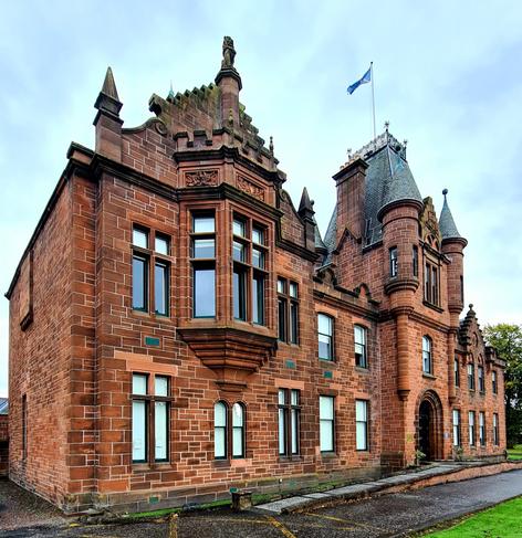 An ornate large red sandstone Jacobean style municipal building.