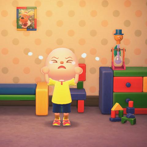 Animal Crossing: New Horizons screenshot. Image is set in a room with colorful wooden block furniture with polka-dot wallpaper and some wooden block toys. In the center of the room is a bald, light skinned islander wearing a custom yellow t-shirt with a red collar, blue shorts, yellow socks, and red kid's shoes. He is intended to be dressed like Caillou. He's crying.