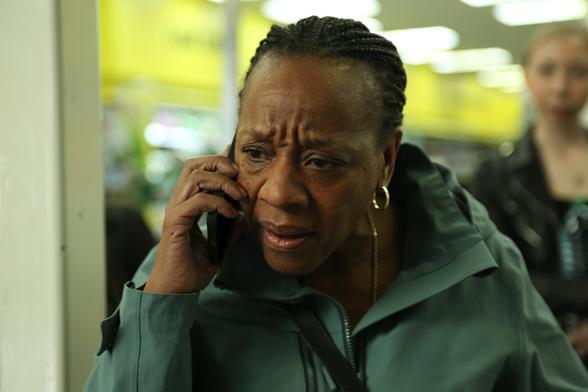 Marianne Jean-Baptiste, as Pansy, holds a phone to her ear while frowning in Hard Truths
