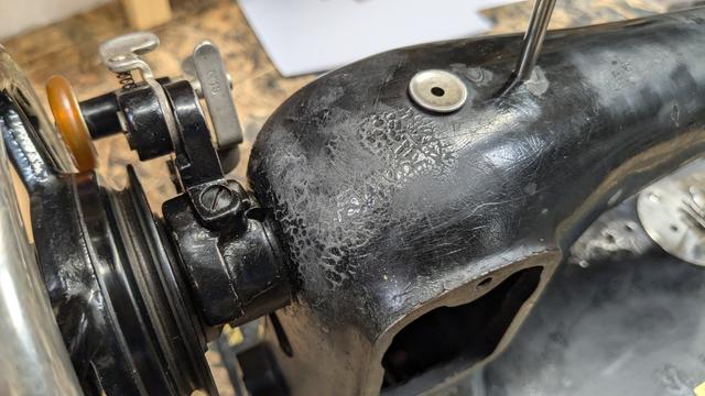 … and sanding the top side of the shoulder near the wheel. On this part it can be seen that the old black lacquer on the casting was flaking off heavily, which has been stabilized with black shellac.