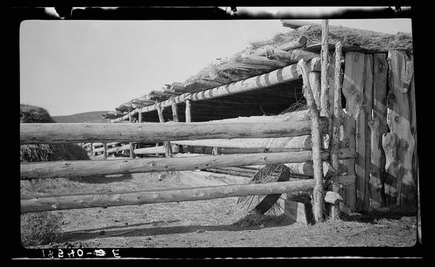 The image shows a black-and-white photograph of an old wooden corral fence, likely from the late 19th or early 20th century. The structure is constructed with horizontal logs and vertical supports, typical of traditional livestock enclosures used by ranchers during that period. In the background, there's evidence of grassy fields extending into a hilly landscape under an overcast sky, indicative of rural plains terrain.

The photograph carries handwritten annotations in white ink at the bottom: "18240-9" on the left and "B E" to the right, which could refer to cataloging information or possibly a reference code. The source for this image is mentioned as Corral near Cordova, New Mexico<box>5 736 1015 921</box>.

This photograph captures not just an architectural element but also offers insight into rural life and the historical context of ranching in America during its frontier era.