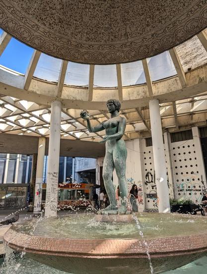 Statue in the center of Belgrade. The statue is placed on the top of the fountain and the whole composition is under the dome with mosaic. All parts are made in the style of the Yugoslavian School of Modernism.