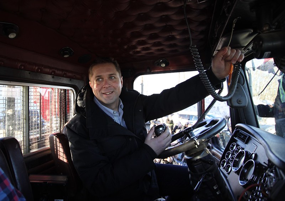 Andrew Scheer sitting in a rig tooting a truck horn. 

Credit @milly7281