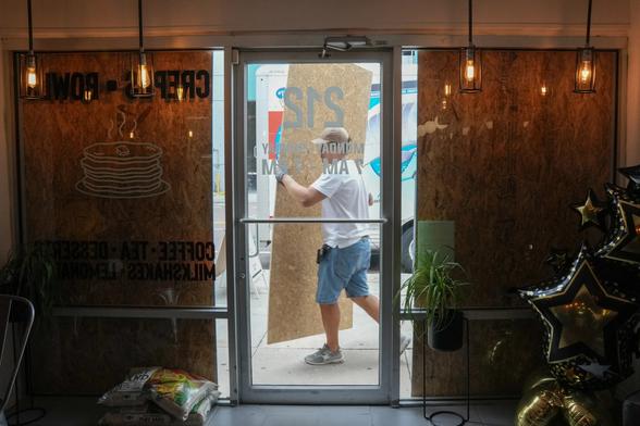 photo - boarding up a storefront ready for Hurricane Milton, FL